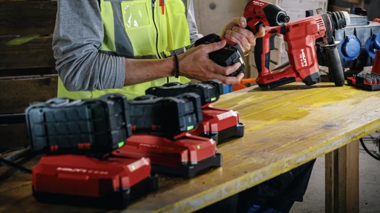 worker cutting objects with a circular saw in a workshop