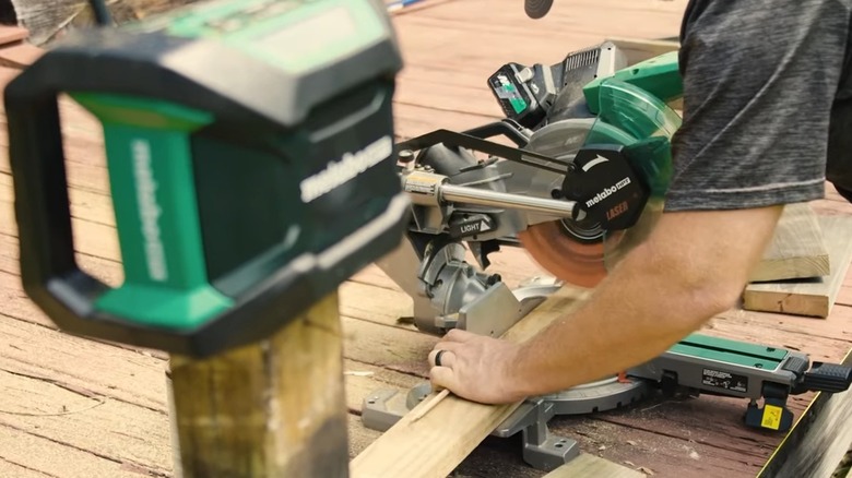 carpenter using a drill on a piece of wood