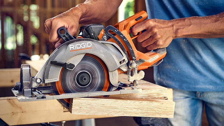 carpenter changing an orbital sander in a workshop