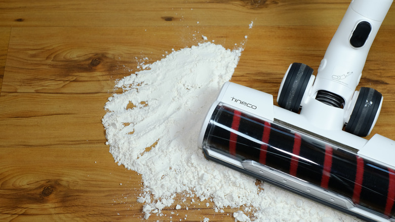 A tineco vacuum cleaning up powder