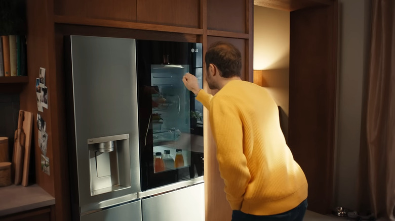 Person knocking on a fridge door