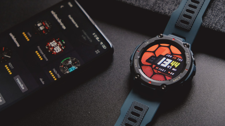 The Amazfit T-Rex Pro next to a smartphone