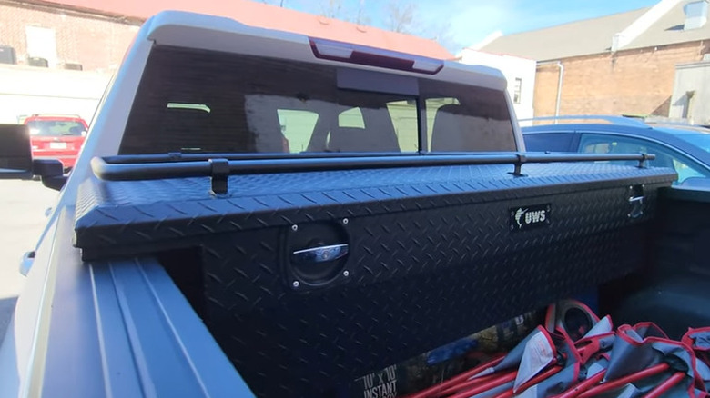 Black toolbox mounted in a pickup truck bed