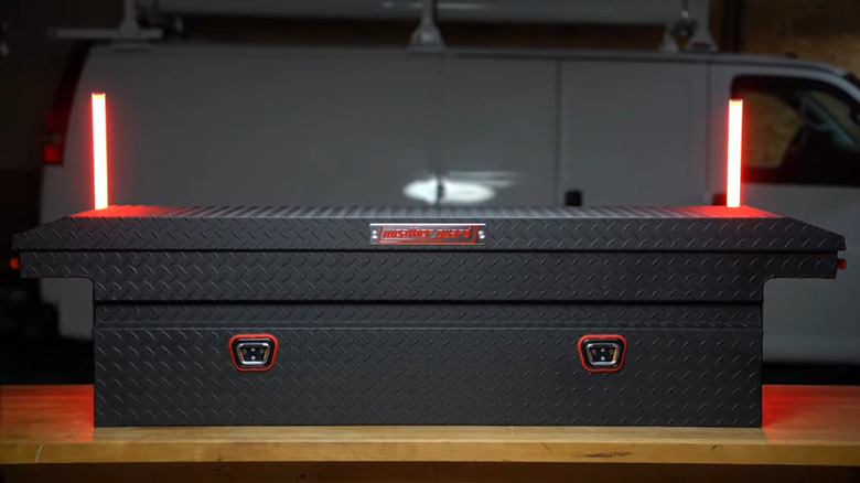 truck bed toolbox on a table in front of a van