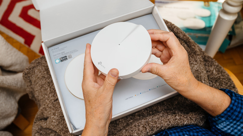 TP-Link mesh router in hand