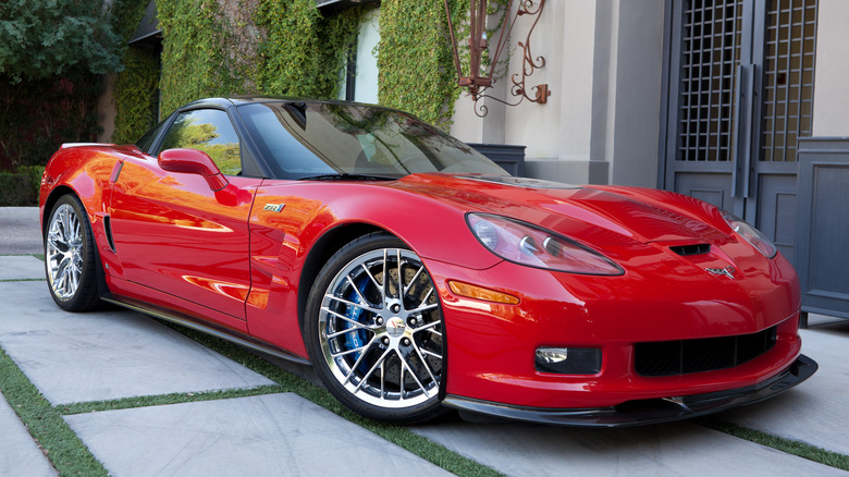 Red 2009 Corvette ZR1 parked in front of house