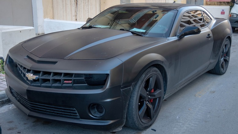 All-black fifth-generation Chevrolet Camaro parked on asphalt