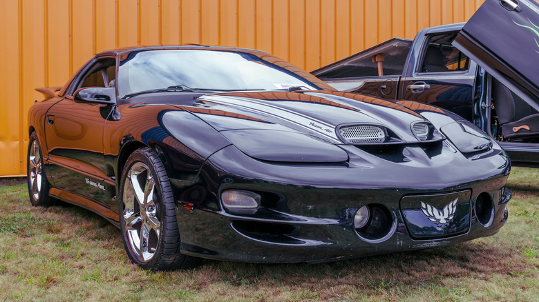 Black 1998 Pontiac Firebird Trans Am parked on grass