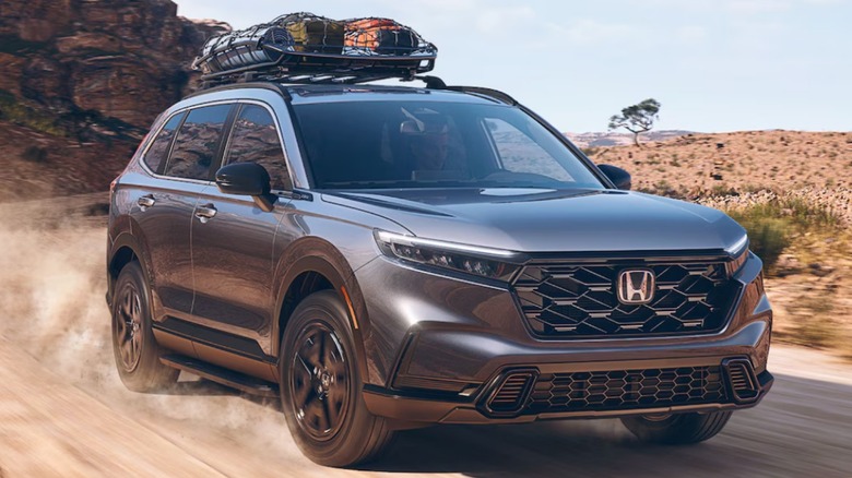 A 2025 Honda CR-V driving on a dirt road.