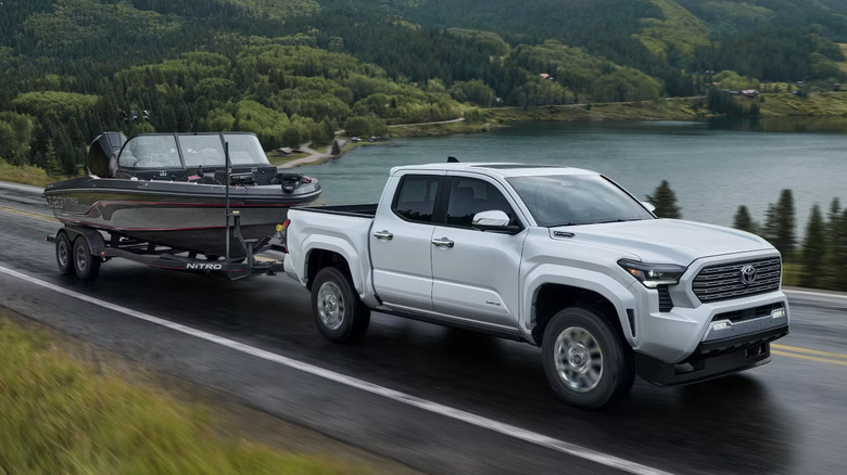 white 2024 Toyota Tacoma towing boat