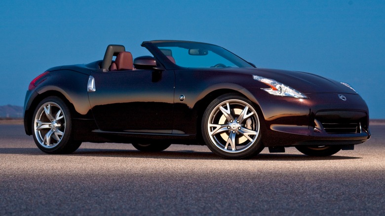 Dark purple Nissan 370Z Roadster parked with top down