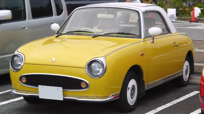 Yellow Nissan Figaro parked