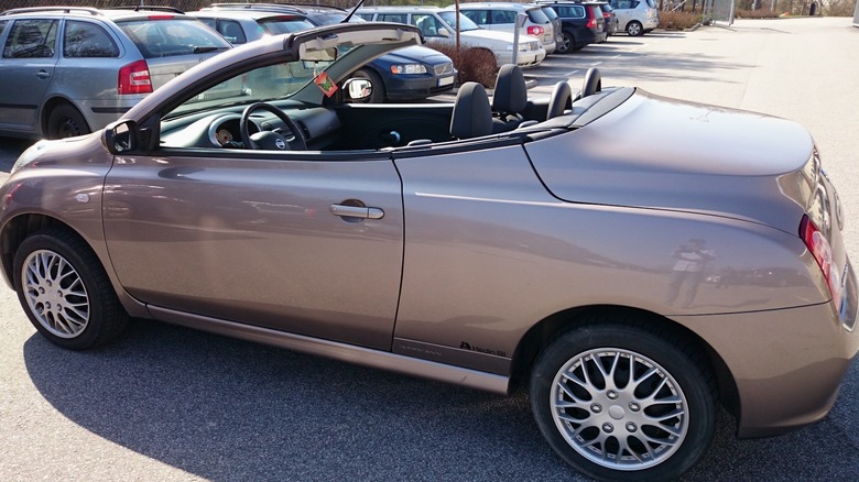 Bronze Nissan Micra C+C parked with top down