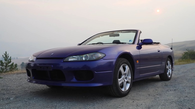 Purple Nissan Silvia Varietta parked on dirt