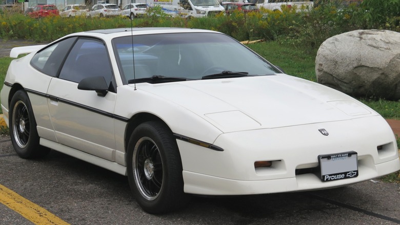 White Pontiac Fiero GT parked in a parking lot