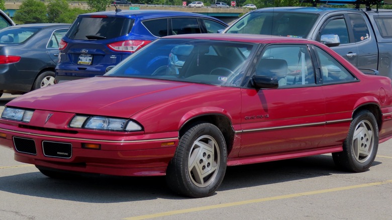 Red Pontiac Grand Prix parked in parking lot