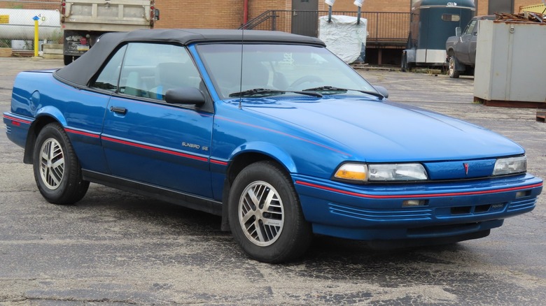 Blue Pontiac Sunbird convertible parked