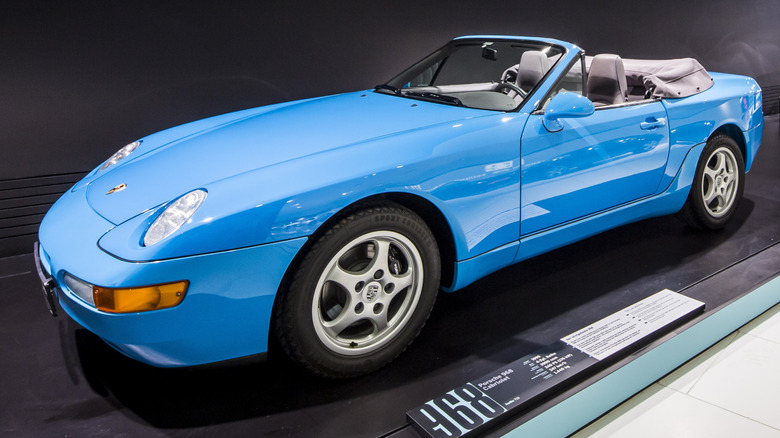 A blue Porsche 968 Cabriolet with its top down.