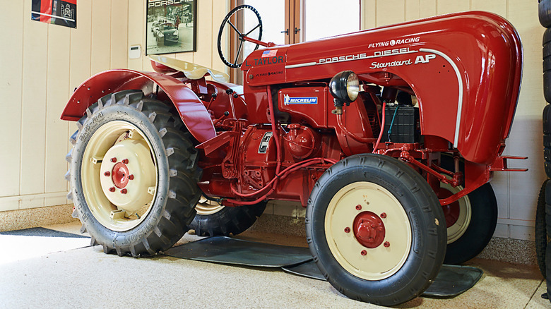 A red Porsche Diesel Tractor indoors