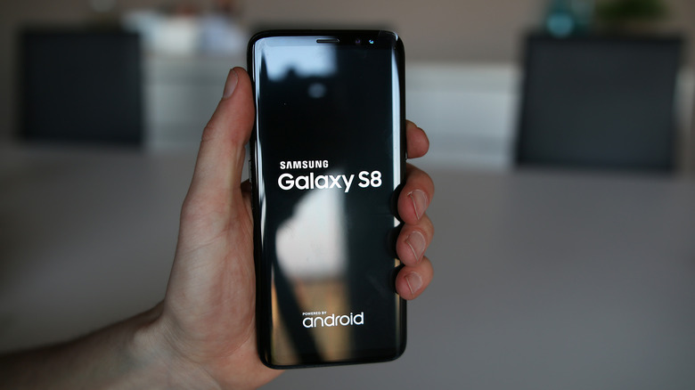 Man holding Samsung Galaxy S8 smartphone