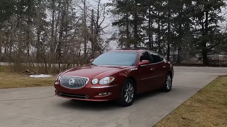 Dark red Buick LaCrosse Super parked on a driveway front 3/4 view