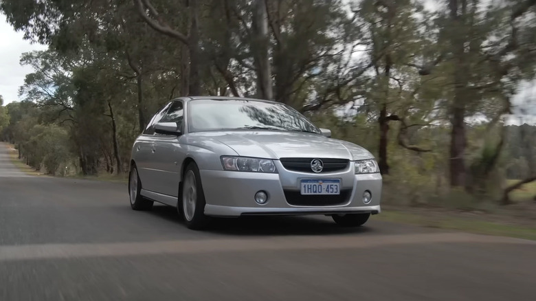 Silver Holden Commodore SS VZ driving at speed front 3/4 view