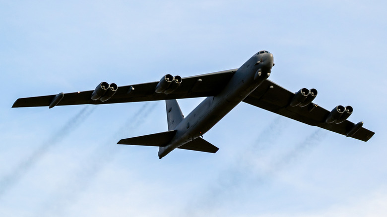 B-52H Stratofortress flying over cloudy skies as seen from below