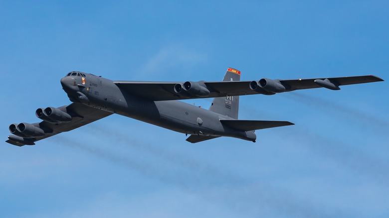 A B-52 Stratofortress flying across the sky as seen from below