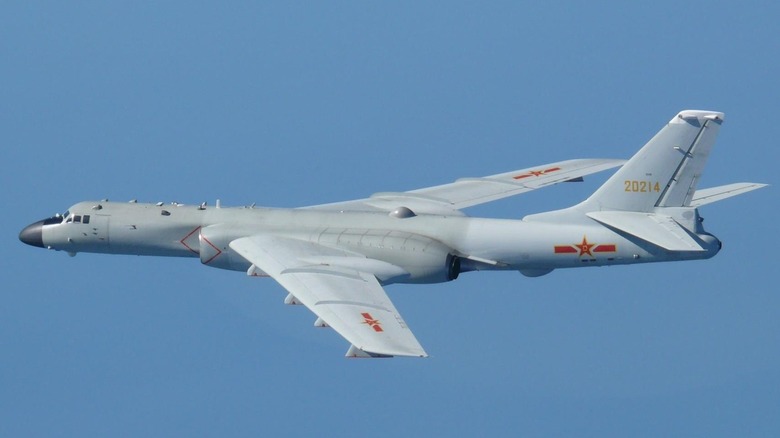 A Chinese PLAAF H-6 strategic bomber flying over blue skies