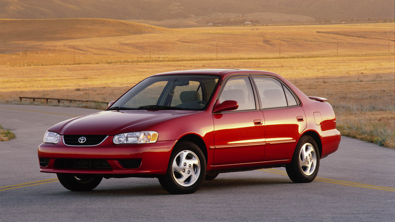 Red Toyota Corolla Sedan E110 front 3/4