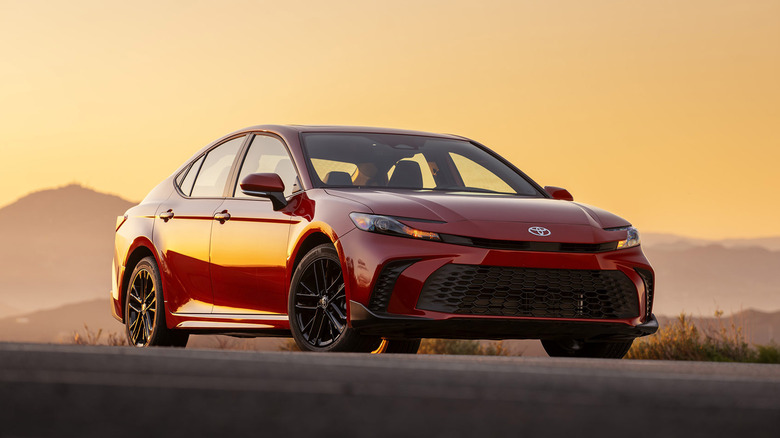 Red 2025 Toyota Camry against a sunset