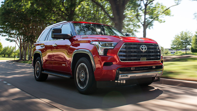 Red Toyota Sequoia driving on road