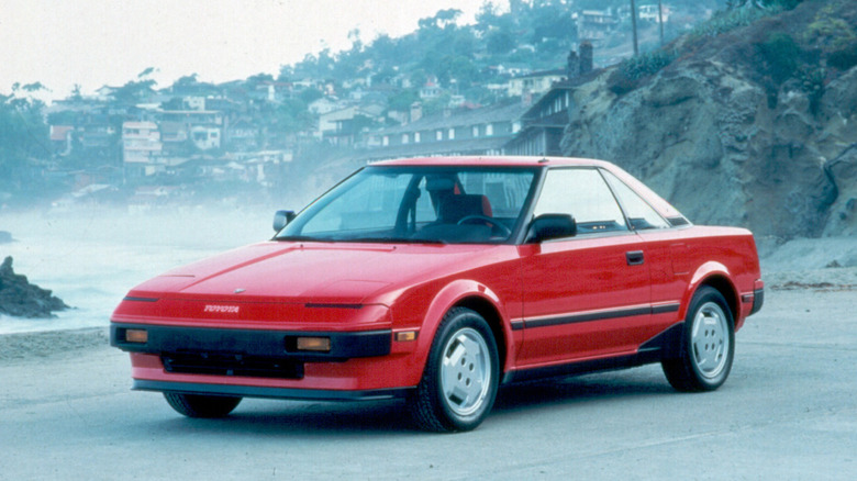 Red Toyota MR2 AW11 parked on a beach