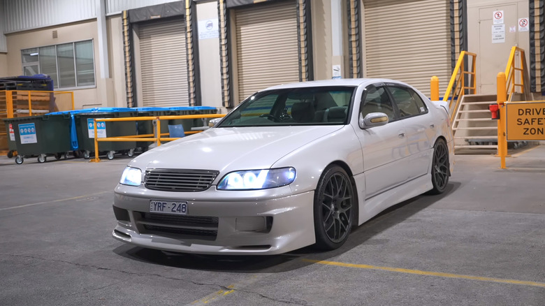 White Toyota Aristo parked inside a warehouse