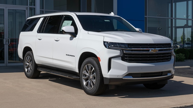 white chevrolet suburban suv truck dealership display