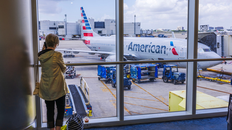 Woman watching American Airlines plane