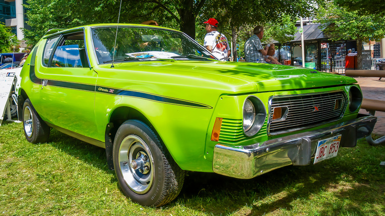 A green AMC Gremlin parked in the grass