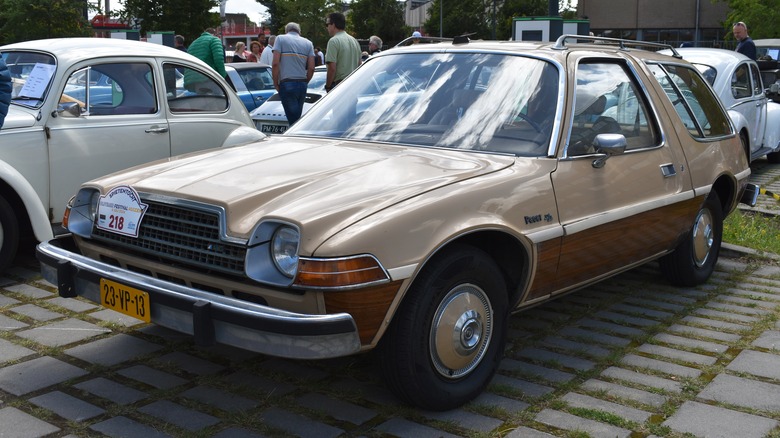 A beige AMC Pacer in a parking lot