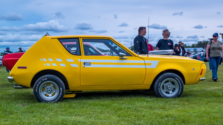 A yellow AMC Gremlin at an auto show