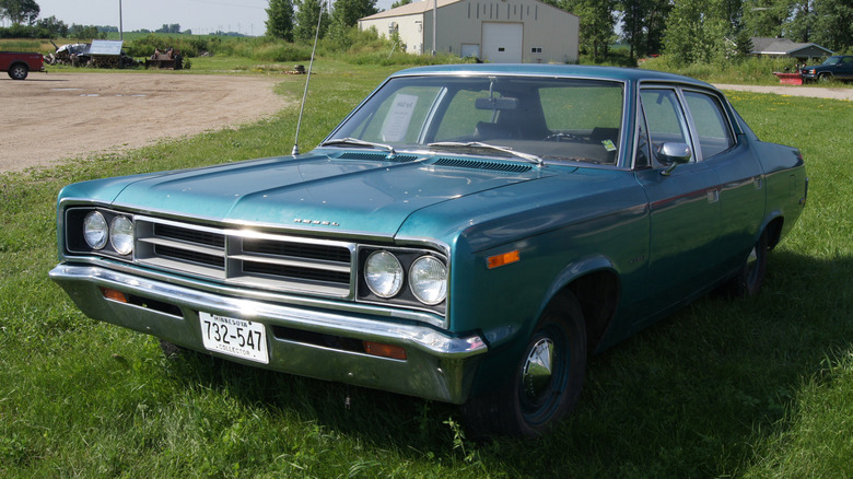 Green 1970 AMC Rebel parked on grass