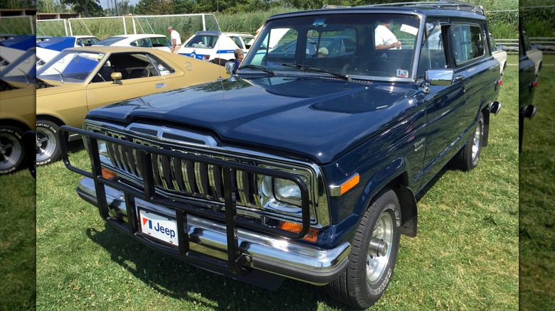 Black 1983 Jeep Cherokee parked on grass