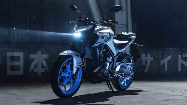 Gray 2025 Yamaha MT-03 parked with headlamp on