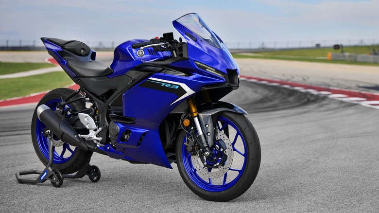 Blue 2025 Yamaha YZF-R3 parked on a race track