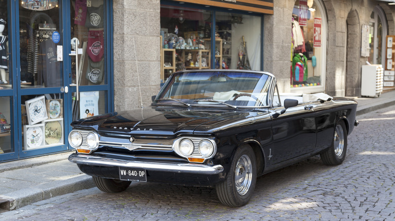 Convertible Chevy Corvair parked on street