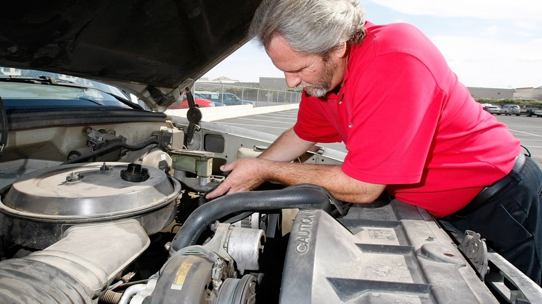 A man working on an old Silverado