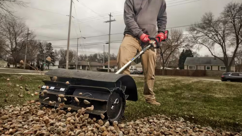 Rubber brush power tool brushing away rocks