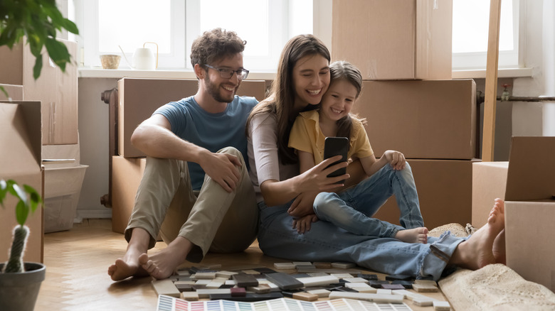 Family using mobile phone at home