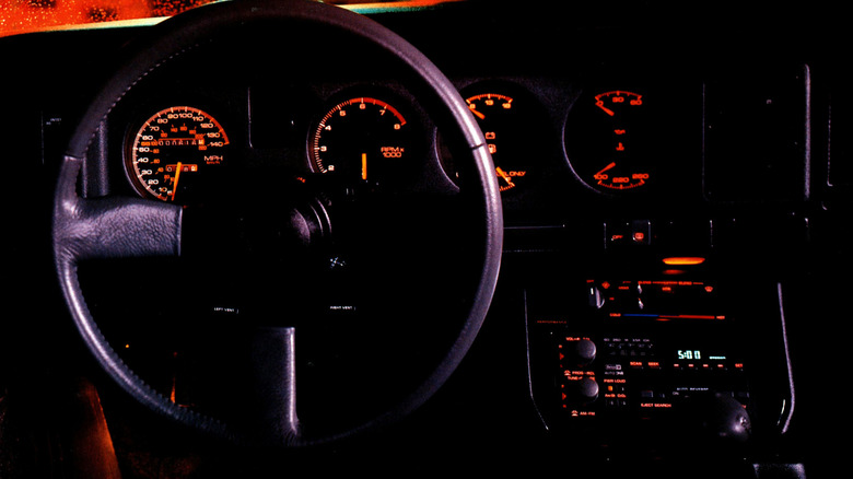 1986 Pontiac Firebird Trans Am interior in dark conditions showing lit instrumentation