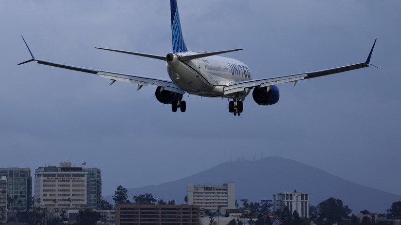 Boeing 737 MAX 8 above city