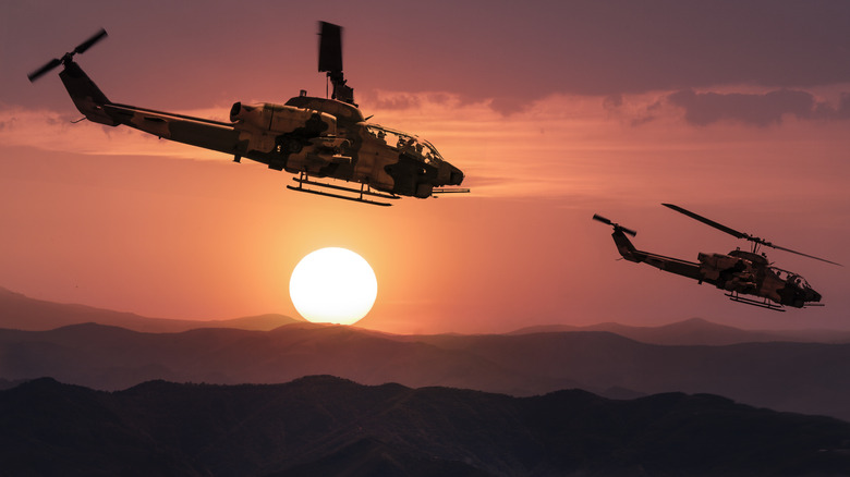 AH-1 Cobra helicopters flying over mountains